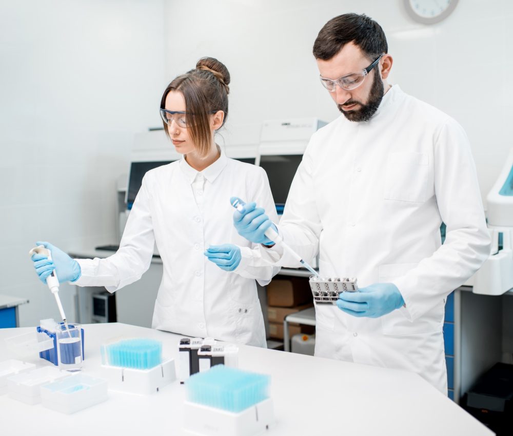 Laboratory assistants working with test tubes